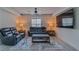 Inviting living room with comfortable seating, ceiling fan, recessed lights, and a large wall-mounted TV at 3570 Mill Creek Drive Sw Dr, Smyrna, GA 30082