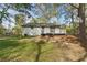 View of the backyard featuring a deck and lush lawn at 7323 Howard Pl, Jonesboro, GA 30236