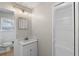 Well-lit bathroom featuring a modern vanity with granite countertop and storage, plus a toilet and wood-look flooring at 7323 Howard Pl, Jonesboro, GA 30236