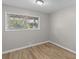 Cozy bedroom featuring natural light from the windows, and durable wood-look flooring at 7323 Howard Pl, Jonesboro, GA 30236