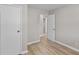 Neutrally decorated bedroom with wood-look flooring and a door leading to another room at 7323 Howard Pl, Jonesboro, GA 30236