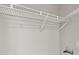 A wire closet shelf is installed on a white wall with water connections at 7323 Howard Pl, Jonesboro, GA 30236