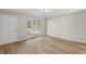 Spacious living area with light wood floors, bright lighting, and neutral walls at 7323 Howard Pl, Jonesboro, GA 30236