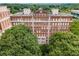 Stunning aerial view of an elegant brick apartment building nestled among lush trees at 1325 Peachtree Ne St # 402, Atlanta, GA 30309