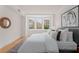 Bright bedroom featuring a bay window, neutral walls, stylish decor, and hardwood floors at 1325 Peachtree Ne St # 402, Atlanta, GA 30309
