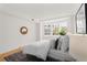 Bright bedroom featuring a bay window, neutral walls, stylish decor, and hardwood floors at 1325 Peachtree Ne St # 402, Atlanta, GA 30309