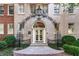 Charming building entrance with wrought iron archway and manicured landscaping at 1325 Peachtree Ne St # 402, Atlanta, GA 30309