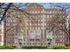 Beautiful brick apartment building with mature trees, manicured lawn and decorative entrance at 1325 Peachtree Ne St # 402, Atlanta, GA 30309