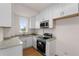 Compact kitchen with white cabinets, stone countertops, and stainless steel appliances at 1325 Peachtree Ne St # 402, Atlanta, GA 30309