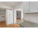 Partial kitchen view with white cabinets and stone countertops shows an adjoining living room at 1325 Peachtree Ne St # 402, Atlanta, GA 30309