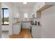 Compact kitchen with white cabinets, stone countertops, and stainless steel appliances at 1325 Peachtree Ne St # 402, Atlanta, GA 30309