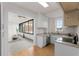Bright living room features oversized windows with views of the trees and adjacent kitchen at 1325 Peachtree Ne St # 402, Atlanta, GA 30309