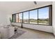 Bright living room features oversized windows with views of the surrounding neighborhood at 1325 Peachtree Ne St # 402, Atlanta, GA 30309