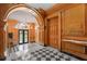 Elegant lobby featuring wood paneling, arched doorway, and checkerboard flooring at 1325 Peachtree Ne St # 402, Atlanta, GA 30309