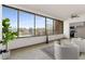 Sun room with large windows and view, chairs, ceiling fan, and small kitchen area in background at 1325 Peachtree Ne St # 402, Atlanta, GA 30309