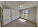 This cozy bedroom features neutral walls, carpet floors, natural light from the window, and two closet doors at 209 Park Ave, Woodstock, GA 30188