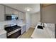 Modern kitchen featuring sleek gray cabinets, stainless steel appliances, and subway tile backsplash at 209 Park Ave, Woodstock, GA 30188