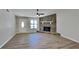 Inviting living room with a stone fireplace, new flooring, and plenty of natural light at 209 Park Ave, Woodstock, GA 30188