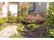 Charming backyard with a wooden bridge over creek and vibrant landscaping at 34 Greenland Trce, Atlanta, GA 30342