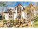 Charming home featuring large windows, a welcoming wood walkway and manicured landscaping at 34 Greenland Trce, Atlanta, GA 30342