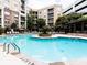 Resort-style pool area with clear blue water, lounge chairs, tables, a gazebo, and surrounding multi-story buildings at 390 17Th Street Nw # 2026, Atlanta, GA 30363