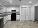 This kitchen features white cabinets, granite counters, and stainless steel appliances at 4933 Bayside Ct, Stone Mountain, GA 30088