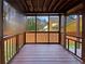 Cozy screened-in porch perfect for relaxation with a wooden railing and flooring at 4933 Bayside Ct, Stone Mountain, GA 30088
