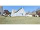 An exterior backyard showing a sloped lawn of a home with light blue siding and a roof with light gray shingles at 1128 Strath Clyde Way, Mcdonough, GA 30253