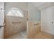 Bright bathroom featuring a tiled shower, safety bars, and a window allowing natural light at 1128 Strath Clyde Way, Mcdonough, GA 30253