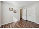 Comfortable bedroom with wood floors, natural light, and a spacious closet at 1128 Strath Clyde Way, Mcdonough, GA 30253