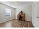 Versatile bedroom with wood floors, a window, and a stylish desk at 1128 Strath Clyde Way, Mcdonough, GA 30253