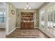 Inviting dining room with hardwood floors, a classic hutch, and natural light from double doors at 1128 Strath Clyde Way, Mcdonough, GA 30253