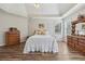 Inviting main bedroom with vaulted ceiling, wood floors, and natural light from large windows at 1128 Strath Clyde Way, Mcdonough, GA 30253