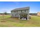 Spacious backyard view with a covered patio and outdoor seating at 111 Felicity Pike, Locust Grove, GA 30248