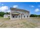 Backyard view showcasing the patio, spacious lawn, and home's exterior at 111 Felicity Pike, Locust Grove, GA 30248