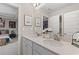 Elegant bathroom featuring double sinks, a large mirror, and modern fixtures at 111 Felicity Pike, Locust Grove, GA 30248