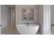 Modern bathroom featuring a freestanding tub, tile surround, and stylish fixtures at 111 Felicity Pike, Locust Grove, GA 30248