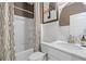 Bright bathroom featuring white cabinets, a shower and tub combo, and modern fixtures at 111 Felicity Pike, Locust Grove, GA 30248