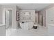 Luxurious bathroom features a soaking tub, marble-look tile, and a separate shower with multiple showerheads at 111 Felicity Pike, Locust Grove, GA 30248