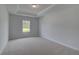Bedroom with a large window and tray ceiling at 111 Felicity Pike, Locust Grove, GA 30248