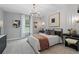 Beautiful bedroom featuring a cozy bed with decorative pillows, a chandelier, and stylish decor at 111 Felicity Pike, Locust Grove, GA 30248
