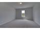 Cozy bedroom with plush carpet and a sunlit window at 111 Felicity Pike, Locust Grove, GA 30248