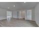 Bonus room with hardwood floors, neutral paint, and access to closets and other rooms at 111 Felicity Pike, Locust Grove, GA 30248