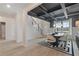 Stylish dining room showcasing dark ceiling beams, unique wallpaper, designer furniture, and open floor plan at 111 Felicity Pike, Locust Grove, GA 30248