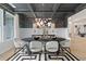 Elegant dining room with striking black ceiling, designer wallpaper, modern table, stylish seating, and natural light at 111 Felicity Pike, Locust Grove, GA 30248