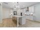 Bright, spacious kitchen with a large center island, stainless steel appliances, and modern lighting at 111 Felicity Pike, Locust Grove, GA 30248