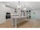 Bright, modern kitchen with stainless steel appliances, a large island, and elegant pendant lighting at 111 Felicity Pike, Locust Grove, GA 30248