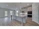 Modern kitchen with a large island, stainless steel appliances, and pendant lighting at 111 Felicity Pike, Locust Grove, GA 30248