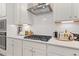 Modern kitchen featuring white cabinets, stainless steel appliances, and a stylish range hood at 111 Felicity Pike, Locust Grove, GA 30248