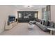 Well-lit living room with plush carpet, stylish furniture, and modern wall decor on an accent wall at 111 Felicity Pike, Locust Grove, GA 30248